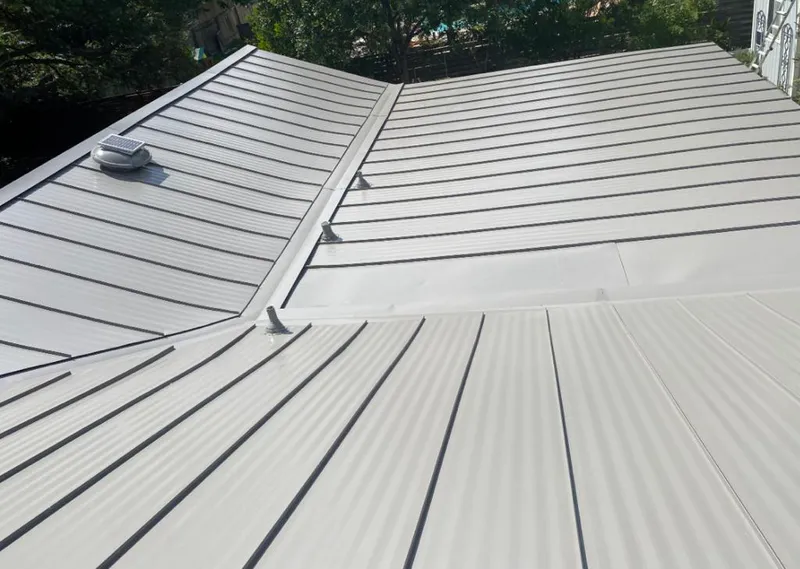 Solar attic fan installed on a metal roof for Roof Ventilation in Athens